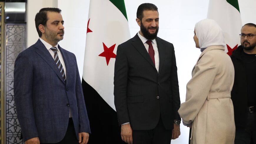Syrian President Ahmad al-Sharaa (R) and Foreign Minister Asaad al-Shaibani (L) bid farewell to participants at the Syrian National Dialogue Conference.