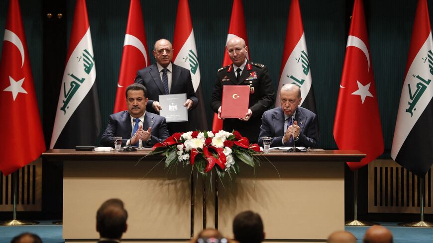 Turkish President Recep Tayyip Erdogan (front-R) and Iraqi Prime Minister Mohammed Shia al-Sudani (front-L) clap after sponsoring the signing ceremony of memoranda of understanding between Iraq and Turkey, in Ankara on May 8, 2025.