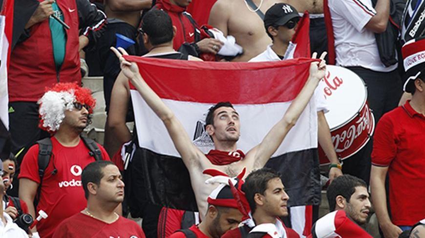 Fans of the Egypt team celebrate during their World Cup 2014 African zone qualifying soccer match against Ghana at the Baba Yara Sports Stadium in Kumasi October 15, 2013. REUTERS/Luc Gnago (GHANA - Tags: SPORT SOCCER) - RTX14CVU