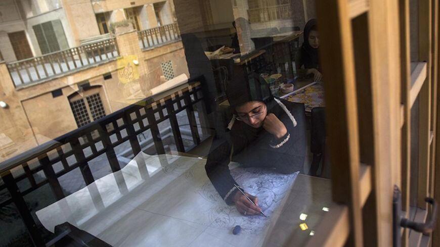 EDITORS' NOTE: Reuters and other foreign media are subject to Iranian restrictions on leaving the office to report, film or take pictures in Tehran. 
A student draws a pattern for a Persian handmade carpet as she sits in a classroom in Isfahan Art University, 450 km (280 miles) south of Tehran November 14, 2011. Persian carpet weaving is a historical part of Iranian culture, dating back to as far as approximately 2,000 years ago. Persian carpets can be mostly divided into three size groups: large (3x4 metre