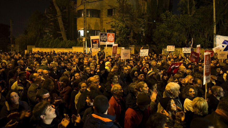 Israeli left-wing activists attend a rally against the contentious bill that would define Israel as the Jewish nation state and enshrine certain rights for Jews, in Jerusalem November 29, 2014. REUTERS/Ronen Zvulun (JERUSALEM - Tags: POLITICS CIVIL UNREST) - RTR4G2WN