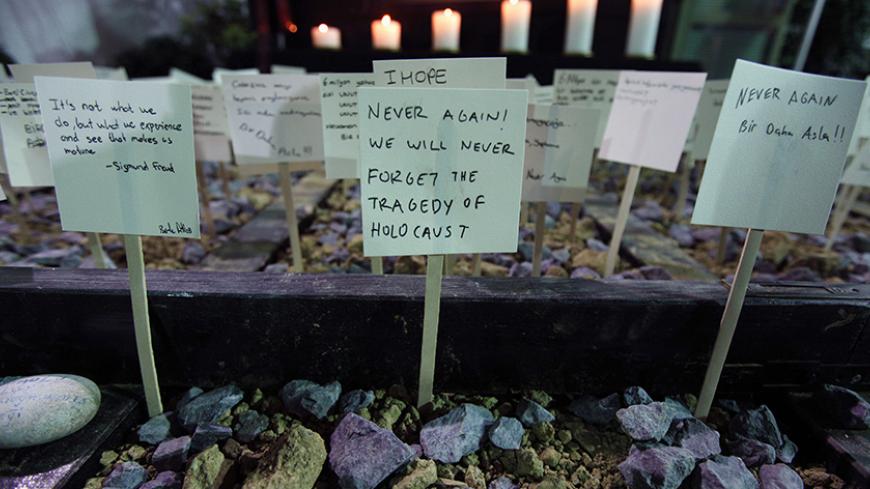 School children from Turkey's Jewish community leave notes on a symbolic railway track during a commemoration event on International Holocaust Remembrance Day at Etz Ahayim Synagogue in Istanbul January 27, 2013. The International Day of Commemoration, which was designated by the United Nations General Assembly to honour Holocaust victims, occurs annually on January 27. REUTERS/Murad Sezer (TURKEY  - Tags: POLITICS RELIGION ANNIVERSARY) - RTR3D1Z7