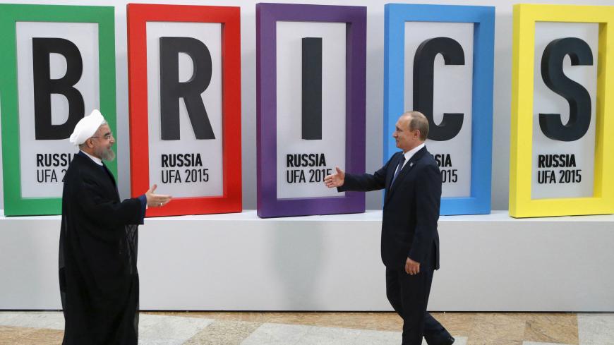 Russian President Vladimir Putin (R) greets Iran's President Hassan Rouhani in Ufa, Russia, July 9, 2015. Rouhani said on Thursday he was grateful to Russia for its efforts to secure an agreement at talks between six major powers and Iran on Tehran's nuclear program.    REUTERS/Sergei Karpukhin      TPX IMAGES OF THE DAY      - RTX1JQOA