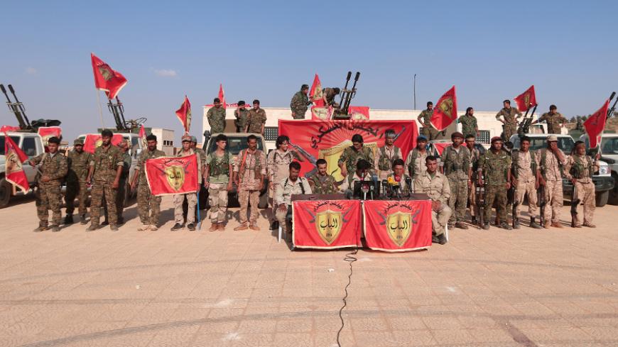 A new coalition of armed groups pose during the statement of the founding of the military council of Al Bab city and its provinces, in Manbij, Aleppo Governorate, Syria August 14, 2016. REUTERS/Rodi Said - RTX2KQNB