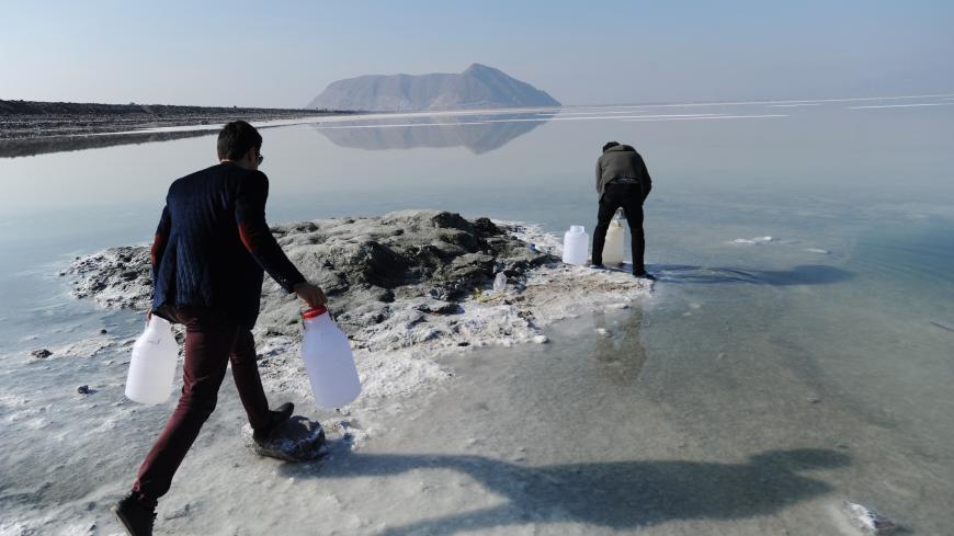 URMIEH, IRAN - JANUARY 23: Iranian university student Vahid Rezaei (R) and his brother Saeed Rezaei collect water samples from the salt-encrusted former lakebed of Iran's shrinking Lake Urmieh, which presents a risk of salt storms and future health and environmental problems on January 23, 2015 in Urmieh, northwest Iran. Once one of the largest salt lakes in the world, it has lost 90 percent of its volume in the past decade and symbolizes the scale of the water crisis facing Iran today. Decades of overuse,