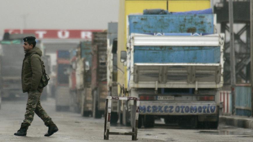 A soldier walks at Ibrahim Khalil border gate between Iraq and Turkey, near Zakhu, February 26, 2008. Turkish products dominate shop shelves in Iraq's Kurdish north. So, even as residents here seethe in anger at Turkey's big military incursion into their homeland, they cannot afford to cut the economic lifeline with their larger neighbour. Picture taken February 26, 2008. To match feature IRAQ-TURKEY/TRADE REUTERS/Ceerwan Aziz (IRAQ) - GM1E42R1FKC01
