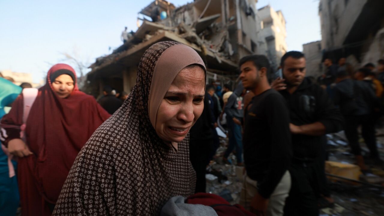 A Palestinian woman reacts as people check the rubble of a building destroyed in the Rafah refugee camp as Israeli air strikes resumed after a truce between Israel and Hamas militants expired A Palestinian woman reacts as people check the rubble of a building destroyed in the Rafah refugee camp as Israeli air strikes resumed after a truce between Israel and Hamas militants expired