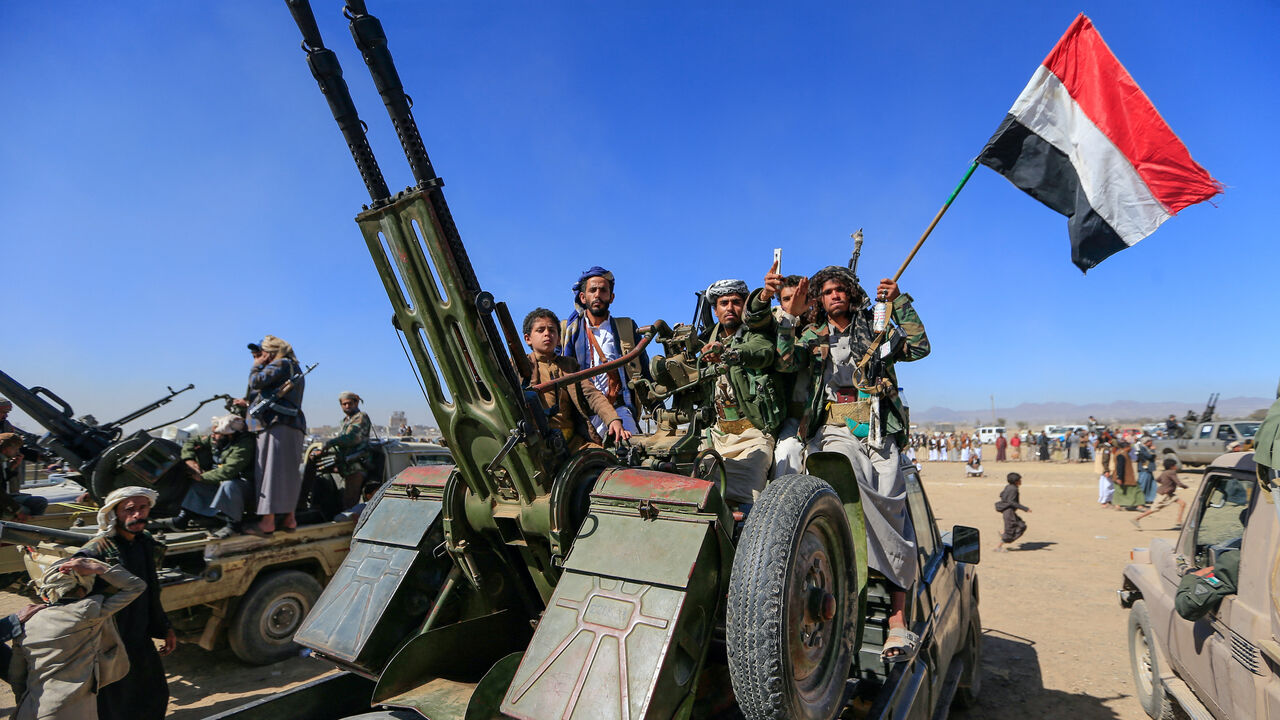 Armed Yemeni tribesmen join Houthi fighters riding military vehicles during an anti-US and Israel rally on the outskirts of the Houthi-controlled capital Sanaa on Jan. 16, 2025.