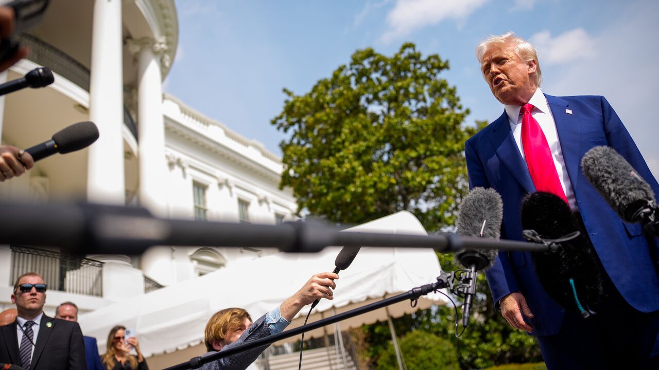 US President Donald Trump speaks to members of the media before boarding Marine One on the South Lawn of the White House on April 3, 2025, in Washington.