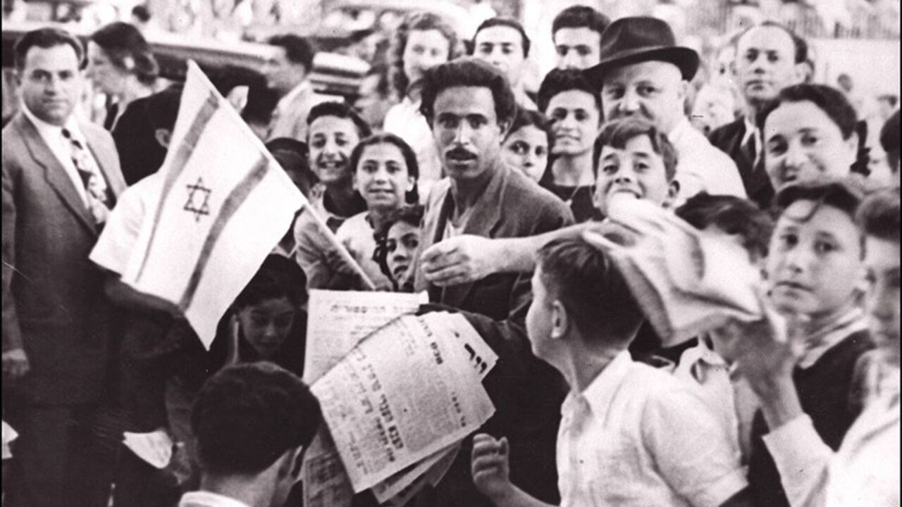 SAPA980303293420 TEL-AVIV, ISRAEL: The crowd of Jews assembled in the streets of Tel Aviv 20 May 1948 a few hours before the British Mandate in Palestine ended, celebrate the proclamation of a new Jewish state of Israel. Israel was founded on 14 May 1948 by the Jewish National Council and was recognized by the United States and the Soviet Union 15 and 17 May. (Photo credit should read AFP/Getty Images)