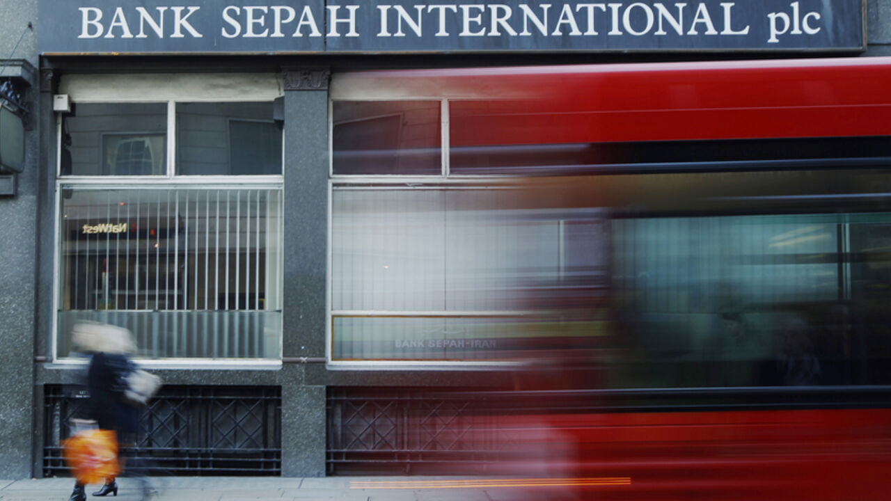 A red London bus passes a branch of Iranian owned Bank Sepah International in London A red London bus passes a branch of Iranian owned Bank Sepah International in London December 22, 2011. Hit by international sanctions, the Iranian banks in London linger on, unable to take on new business. The pressure on them is rising. Last month, the UK forbid its banks to do any business with Iranian banks after a new report from a nuclear watchdog highlighted further concerns about the possible military dimensions to Iran's nuclear programme. REUTERS/Luke MacGregor (BRITAIN - Tags: BUSINESS POLITICS