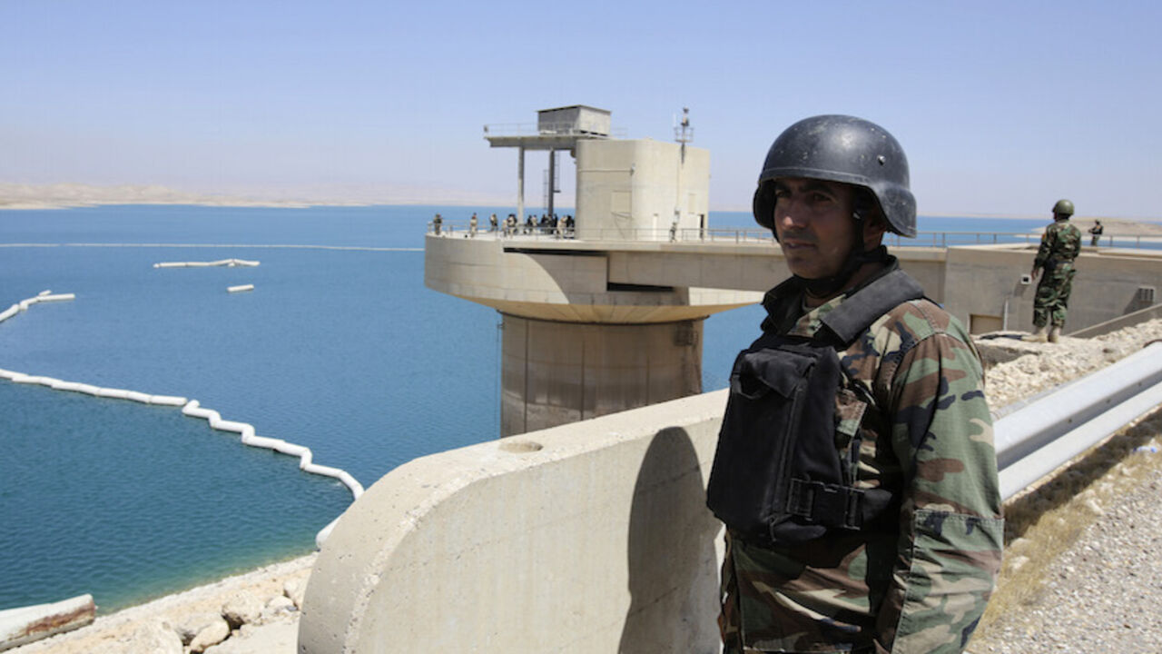 IRAQ-SECURITY/MOSUL-DAM Peshmerga fighters stand guard at Mosul Dam in northern Iraq August 21, 2014. Despite its structural faults, the country's biggest dam at 3.6 km long, built by a German-Italian consortium in the 1980s, is a vital water and power source for Mosul, Iraq's largest northern city of 1.7 million residents. Control the dam and you control the 'keys' to the city. With that in mind, Islamic State insurgents who captured swathes of Iraq and Syria and declared a caliphate, wrested control of the dam from Kurdish force