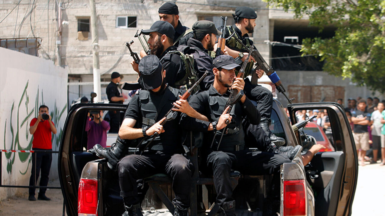 ISRAEL-PALESTINIANS/HAMAS Members of Palestinian security forces loyal to Hamas ride a truck outside a Hamas-run military court where alleged collaborators with Israel are prosecuted, in Gaza City May 21, 2017. REUTERS/Mohammed Salem TPX IMAGES OF THE DAY - RTX36SVG