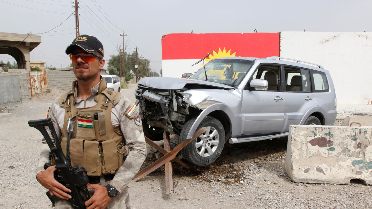 IRAQ-ENERGY/KIRKUK-GAS A member of the Iraqi Kurdish security forces stands guard next to the car of Mohammed Younis, a senior official of Iraq's state-run North Gas Company (NGC) who was killed by gunmen, in the northern oil city of Kirkuk, Iraq, May 2, 2017. REUTERS/Ako Rasheed TPX IMAGES OF THE DAY - RC1FC8168D00
