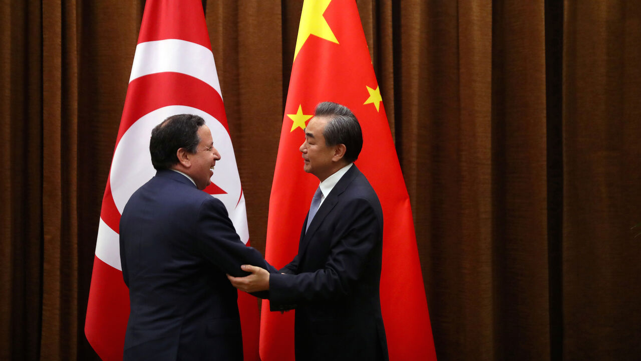 CHINA-TUNISIA/ Tunisia's Foreign Minister Khemaies Jhinaoui and Chinese Foreign Minister Wang Yi shake hands as they pose for a photo before a meeting at the Ministry of Foreign Affairs in Beijing, China, July 19, 2017. REUTERS/Mark Schiefelbein/Pool - RC1D72BC9610