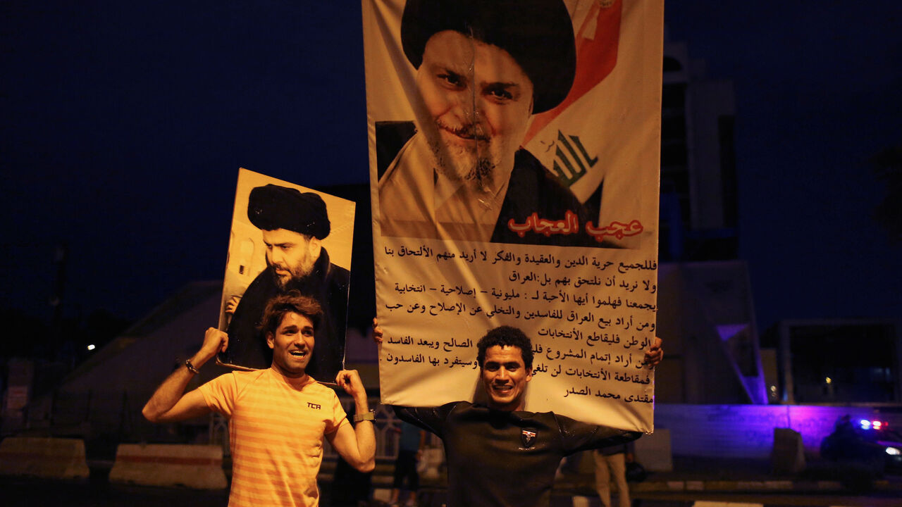 IRAQ-ELECTION/ Iraqi supporters of Sairun list celebrate with portraits of Shi'ite cleric Moqtada al-Sadr, after results of Iraq's parliamentary election were announced in Baghdad, Iraq May 14, 2018. REUTERS/Thaier al-Sudani TPX IMAGES OF THE DAY - RC1278A66440