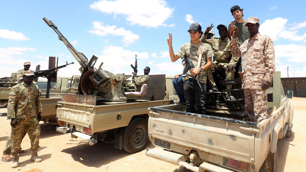 1227708204 Fighters loyal to the UN-recognised Libyan Government of National Accord (GNA) secure the area of Abu Qurain, half-way between the capital Tripoli and Libya's second city Benghazi, against forces loyal to Khalifa Haftar, who is based in eastern Benghazi, on July 20, 2020. - Since 2015, a power struggle has pitted the (GNA) against forces loyal to Haftar. The strongman is mainly supported by Egypt, the United Arab Emirates and Russia, while Turkey backs the GNA. (Photo by Mahmud TURKIA / AFP) (Photo by MAHMU
