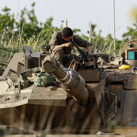 An Israeli soldier checks a Merkava battle tank deployed at a position in the Israel-annexed Golan Heights along the border with southern Syria on March 25, 2025.