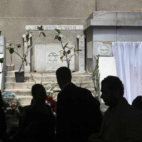 Diplomats from the United States and Israel are silhouetted as they join about 100 mourners at a ceremony, held on Thursday in memory of veteran Jewish leader Carmen Weinstein, at Sha'ar Hashamayim (Gate of Heaven) synagogue in downtown Cairo, April 18, 2013. Weinstein, 82, died last Saturday at her home in Cairo where she was known over the past two decades for leading efforts to preserve the overwhelmingly Muslim country's Jewish heritage. REUTERS/Asmaa Waguih  (EGYPT - Tags: RELIGION POLITICS OBITUARY) -